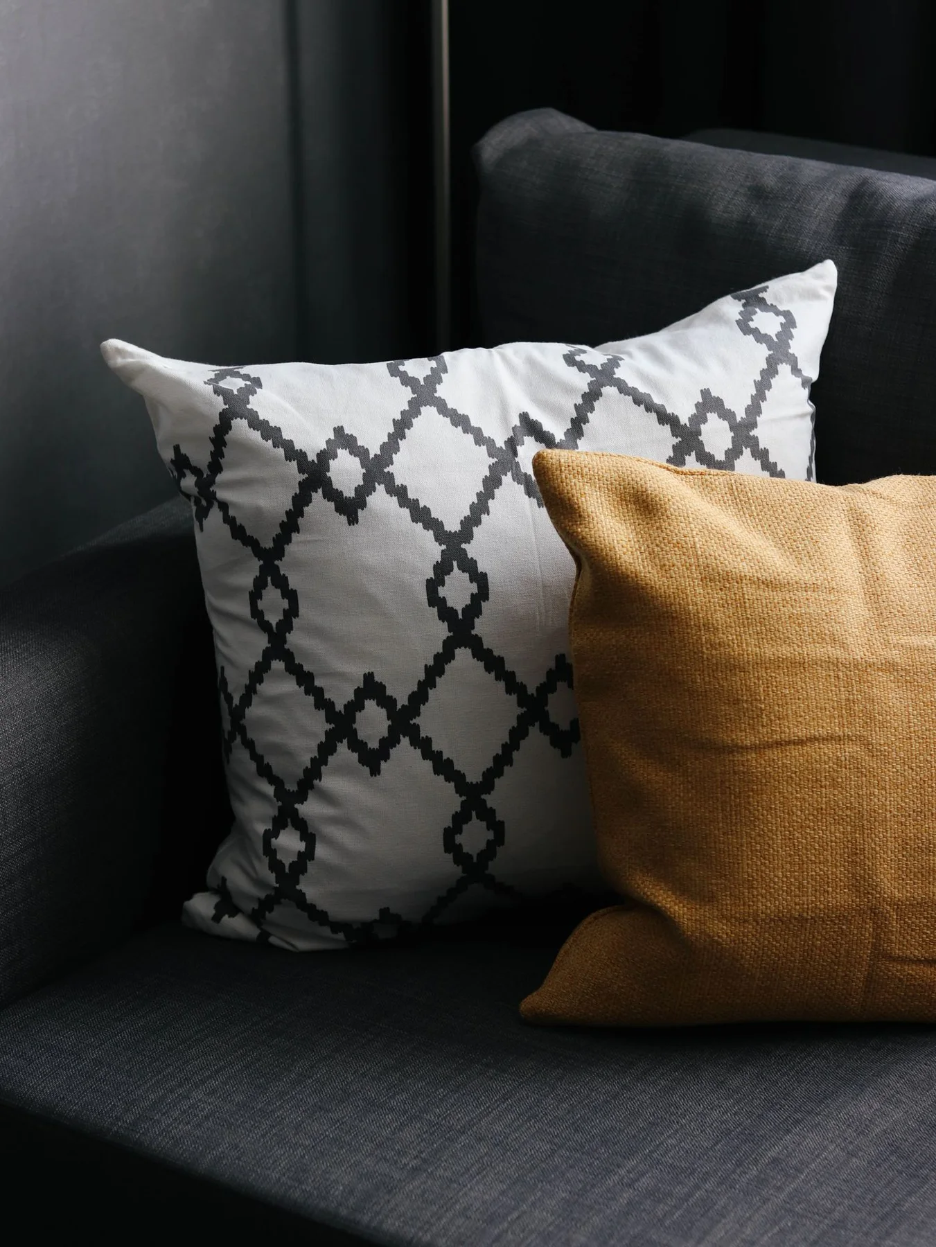 A close view of cushions with geometric covers on a sofa.